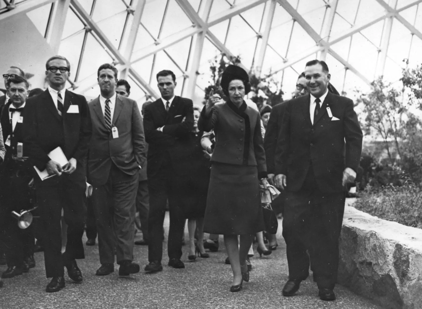 First Lady Lyndon Johnson tours the show dome with a group of men in suits
